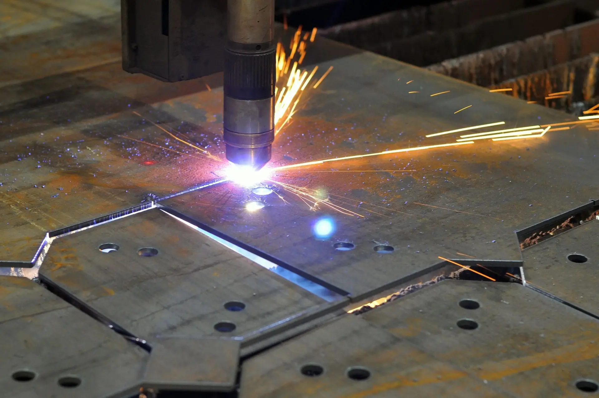 CNC plasma cutting machine processing steel plate for custom fabrication, weldments, and assemblies